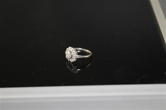A white metal and eleven stone diamond circular cluster ring, size K, gross weight 3.1 grams.